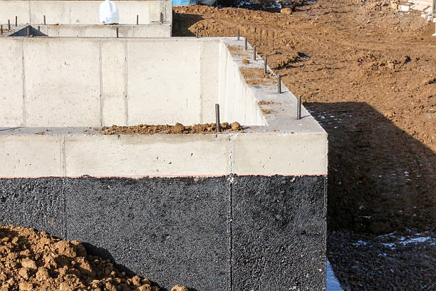 Weatherproofing sealant on a concrete foundation