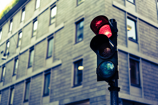 Red Traffic light in downtown in soft vintage tone