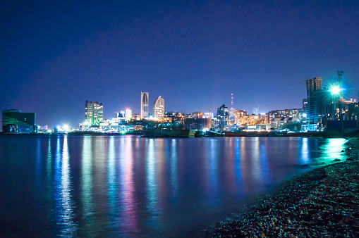 night sea sight with streets, buildings and street lights reflected in the sea, Vladivostok