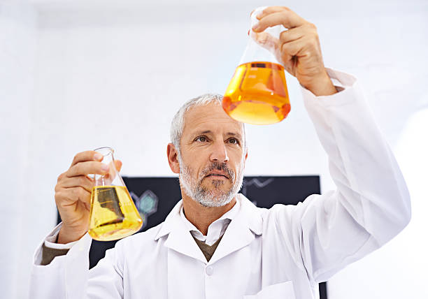 Shot of a mature male scientist examining the results of an experiment in his lab