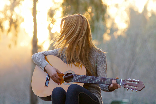 young women with guitar in outdoor