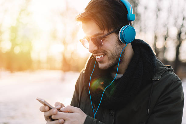 istock Man with headphones texting on smartphone 533259133