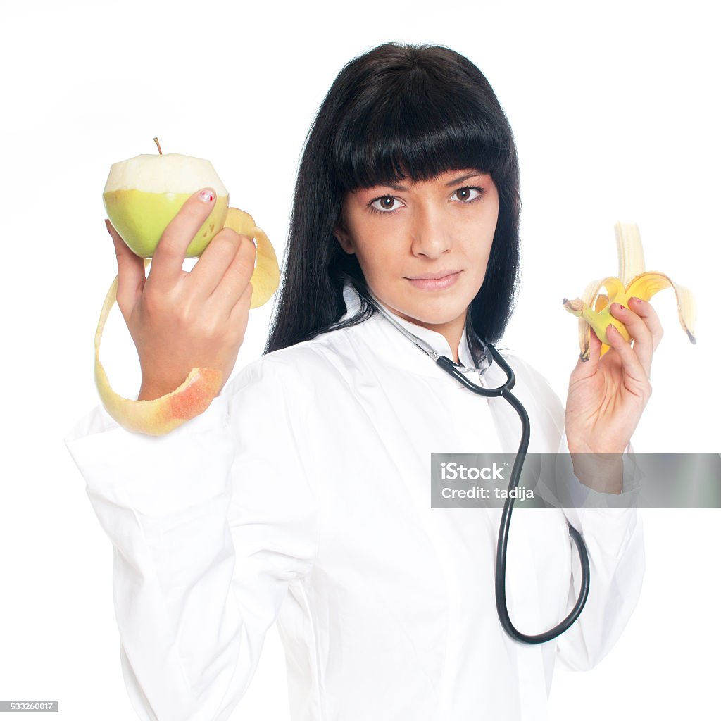 Doctor Nutritionist with Fruit A doctor holding apples and a banana 2015 Stock Photo