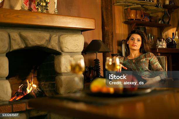 Mature Attractive Pensive Woman Near The Fireplace Stock Photo - Download Image Now - 2015, 30-39 Years, Adult