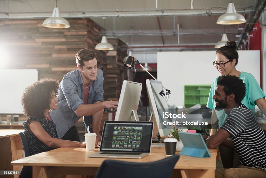 Design is creativity with strategy Shot of a diverse group of young designers working in their office Laptop Stock Photo