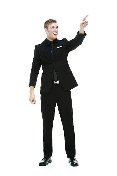 istock Cheerful businessman pointing away 533274029