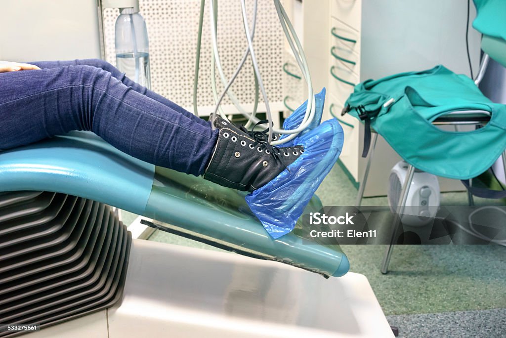 patient's legs In a shoes covers in a dental chair 2015 Stock Photo