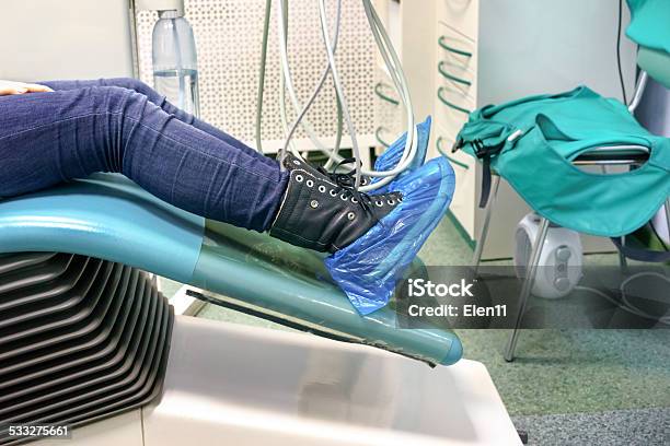 Patients Legs In A Shoes Covers In A Dental Chair Stock Photo - Download Image Now - 2015, Cable, Casual Clothing