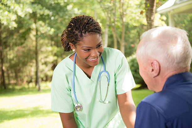 istock Healthcare: Kind nurse talks with senior man outside. Nursing home. 533276177