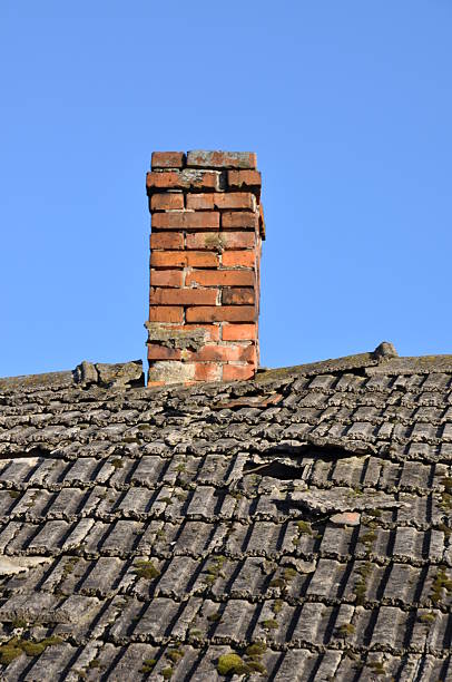 istock Old roof with brick chimney 533277065