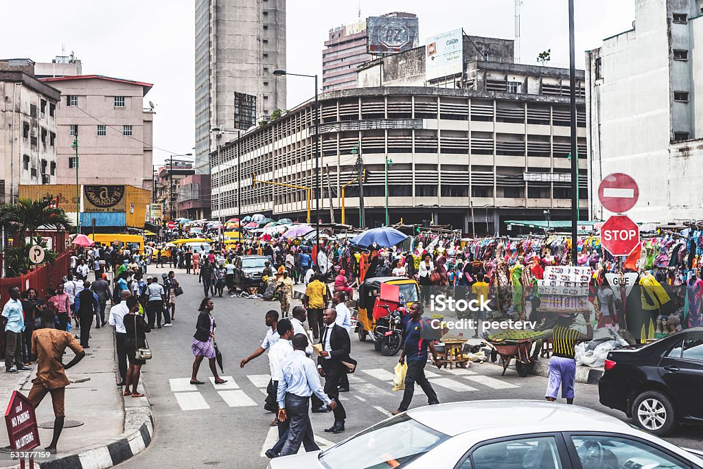 Streets of Lagos downtown. Lagos Island's commercial district, businessmen and market people crossing the street. Africa Stock Photo