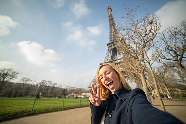 istock Funny woman taking selfie at Eiffel tower 533277265