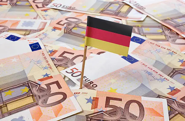 Flag of Germany sticking in european bank notes.