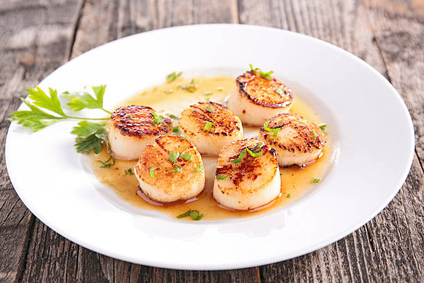 seared scallop seared scallop savory sauce photos stock pictures, royalty-free photos & images