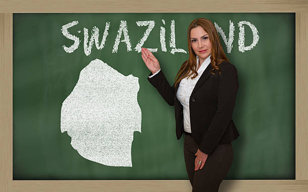 istock Teacher showing map of swaziland on blackboard 533292653