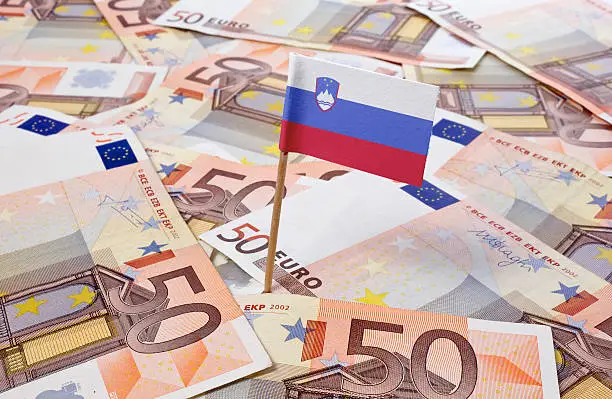 Flag of Slovenia sticking in european bank notes. 