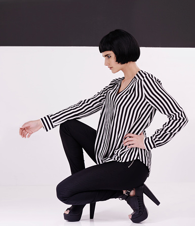 Studio shot of a retro-stylish young woman against a black and white background