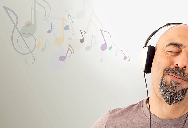 A young man putting on headphones