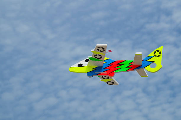 istock colorful toy plane against blue sky. 533296477