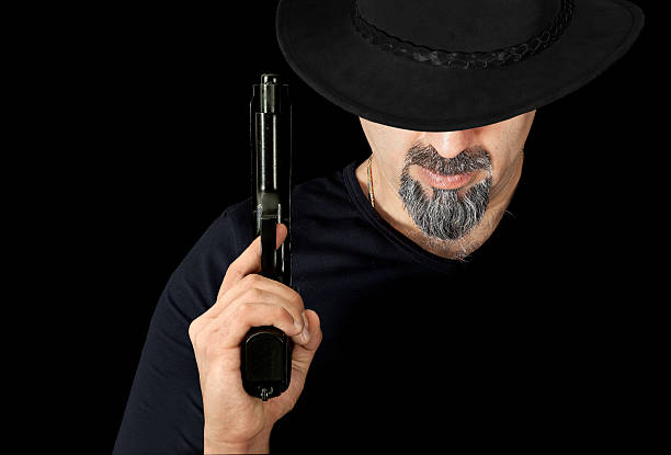 istock The man in black holding a gun 533296531