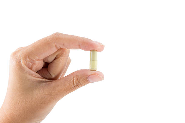 istock Isolated of Hand holding a pill capsule. 533296935