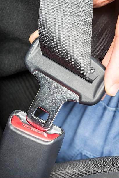 istock Person fastening a seatbelt in a car 533308637