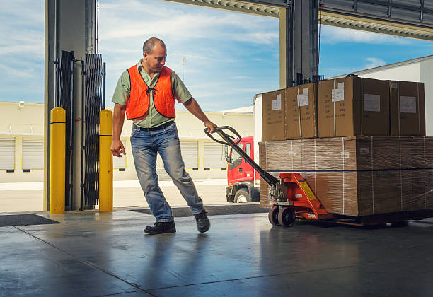 istock Worker with hand pallet truck 533310135