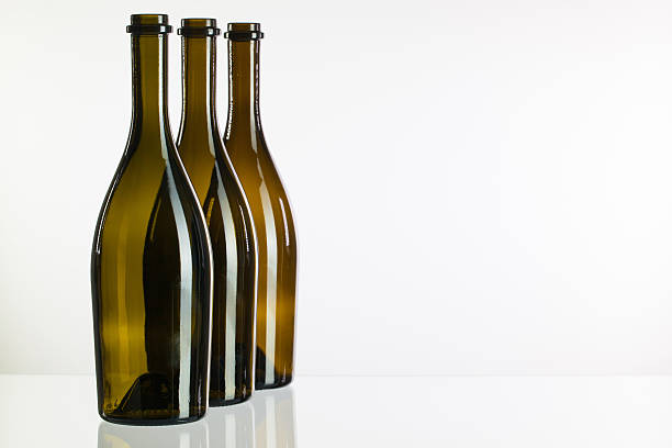 istock Empty bottles of wine on a glass desk 533314623