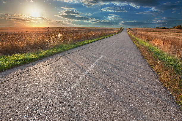 istock Driving on an empty asphalt road at sunset 533315357