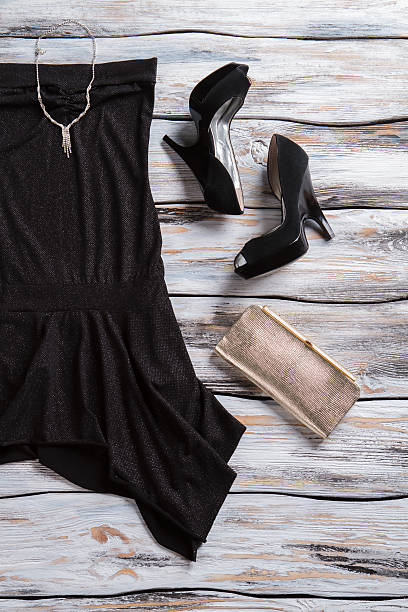 istock Black dress and silver purse. 533327992