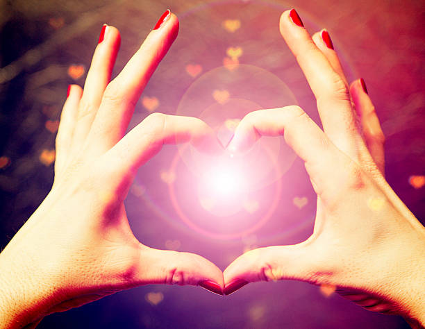 istock love shape hand  on heart bokeh background 533329243