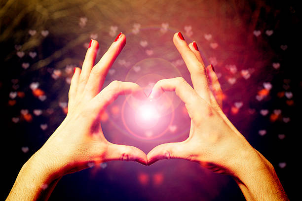 istock love shape hand with heart bokeh background 533329275