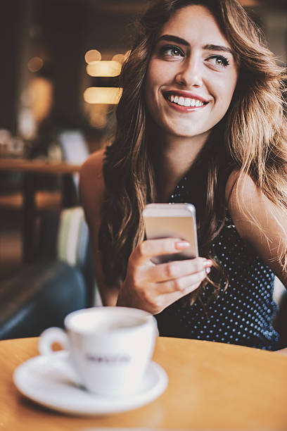 istock Young woman texting in coffee shop 533329616