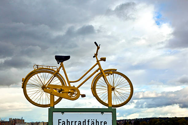 old yellow bike on a roof as hint for a bike ferry in dark clouds
