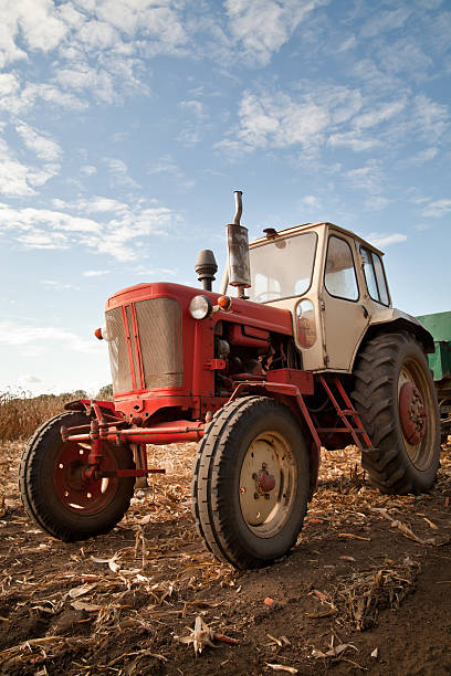 istock old tractor in field, against a cloudy sky 533330981