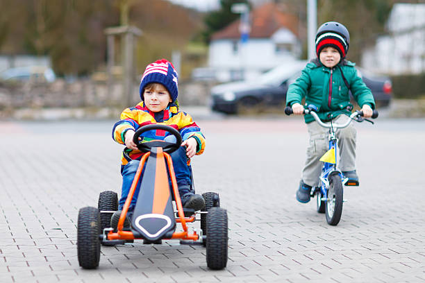 istock Two little boys playing with race car and bicycle 533332464