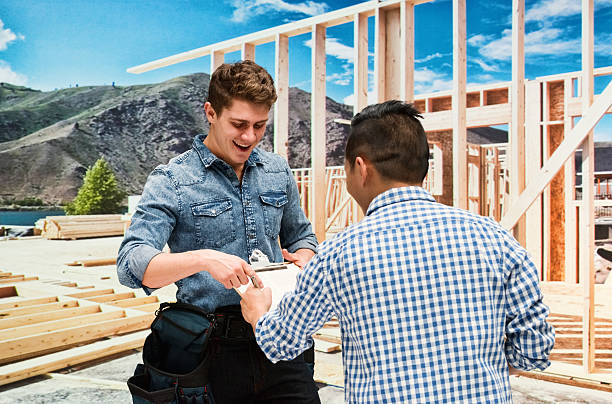 Smiling building contractor discussion with man Smiling building contractor discussion with manhttp://www.twodozendesign.info/i/1.png 24 x 24 frame stock pictures, royalty-free photos & images