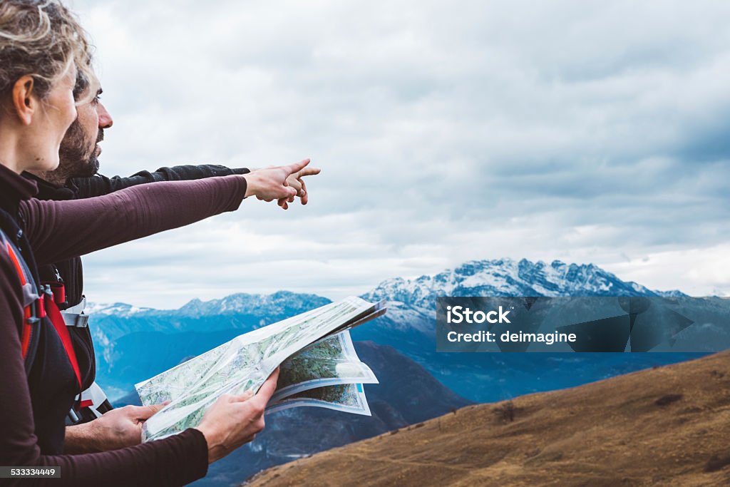 Hiking couple with map in mountain hiking couple with map in mountain. Guidance Stock Photo