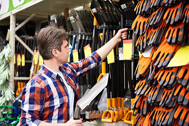 istock Man chooses shovel in shop 533334944