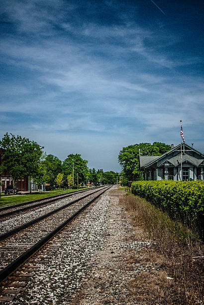 Twin railway lines running through the small Michigan town of Chelsea. The small Chelsea trin station in on the right.