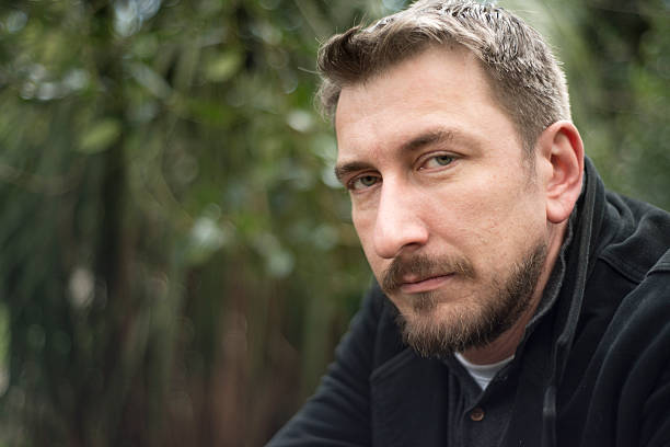 istock Handsome man looking to camera in park 533335684