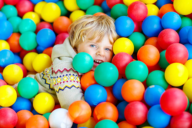 istock child playing at colorful plastic balls playground 533335936