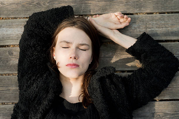 istock attractive woman sleeping on wooden floor 533339310