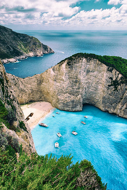 Shipwreck Beach Of Zakynthos The famous Shipwreck Beach of Zakynthos, though to the locals it's Navagio Beach. Stranded on the sand is the wreck of the Panagiotis (originally built in Scotland in 1937, and called the Saint Bedan), wrecked in 1980 and possibly engaged in nefarious, smuggler-type activities. ionian sea photos stock pictures, royalty-free photos & images