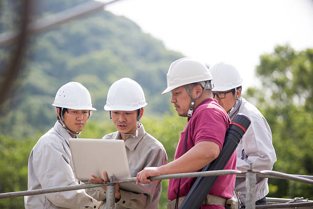 istock Four engineers having a meeting at building construction site 533342218