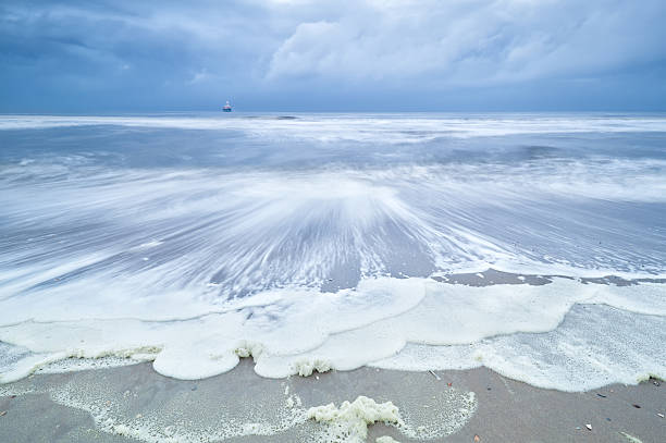 istock North sea coast with ship on waves 533342254