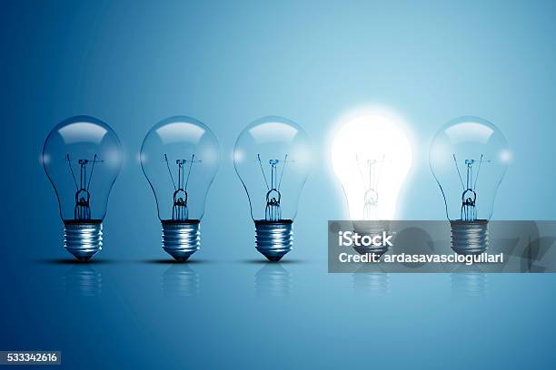 Five Bulbs And One Of Them Is Glowing Stock Photo - Download Image Now - Light Bulb, Inspiration, Ideas