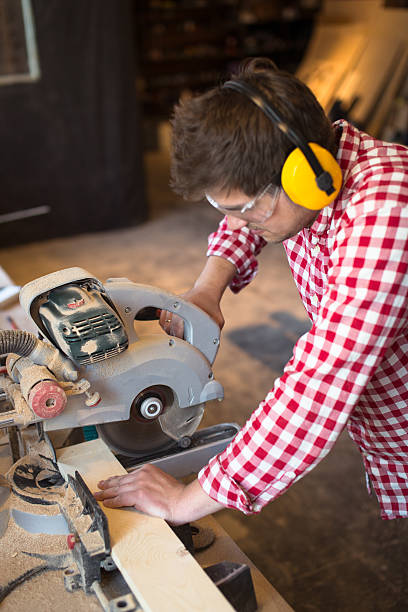 istock master carpenter with headphones and glasses saws  board circula 533343530
