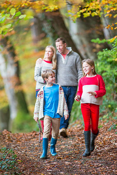 istock Family Walking through the Woods 533343917