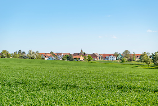 sunny illuminated idyllic rural springtime scenery around a small village  in Hohenlohe, a district in Southern Germany